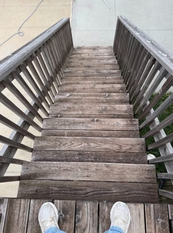 Weathered deck steps before the project